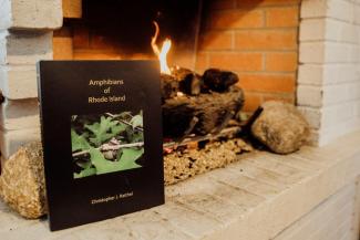 Amphibians of Rhode Island book next to fireplace