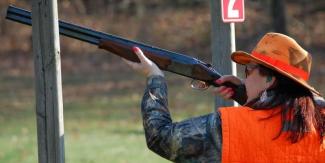 woman aiming shotgun