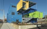 blue green and yellow train cars put together to form an office building