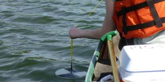 RIDEM staff measure water clarity with a secchi disk