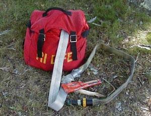 red backpack with flat firehose coming out of it