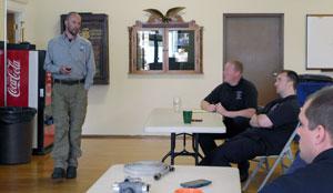 Man lecturing other men in a classroom-type setting