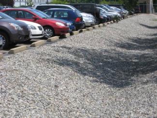 Gravel infiltration trenches surround the parking lot.