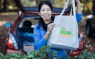 Local grower holding an RI Grown bag